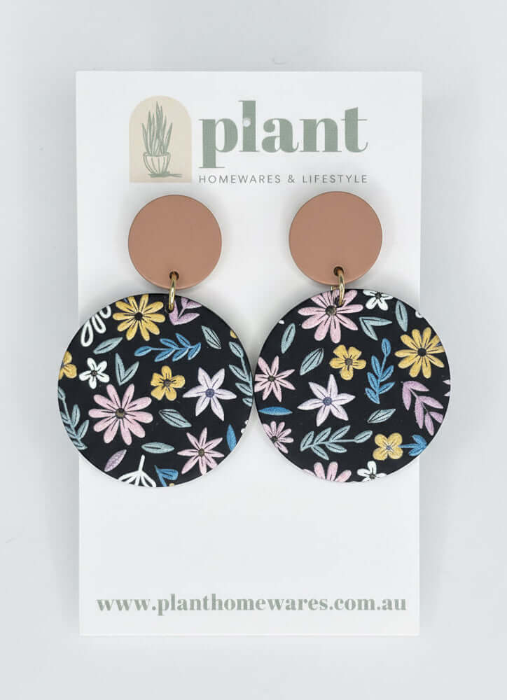 Floral earrings on a 'Plant Homewares & Lifestyle' branded card.