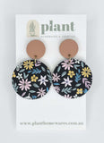 Floral earrings on a 'Plant Homewares & Lifestyle' branded card.
